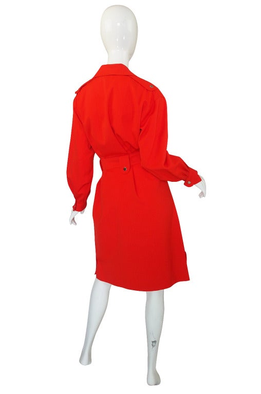 This is so smart and chic! It is a little red trench made of a spring weight fabric. It is so pristine that I doubt it was ever worn at all and only has been cleaned once when I acquired it to freshen it up. It's like it walked out of a time capsule