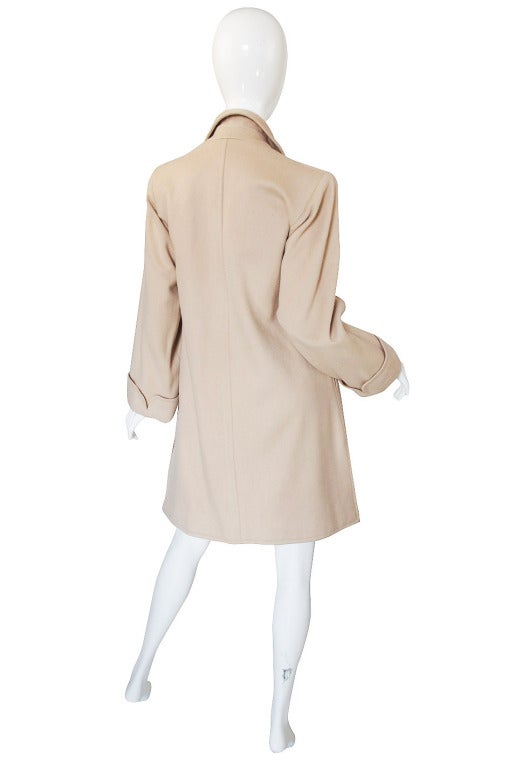 This is a classic Yves Saint Laurent piece that will never go out of style! I love the chic  car coat feel of it and its easy shape and classic camel color that is a lighter shade so feels softer then say that trench coat camel. Its cut with a nod