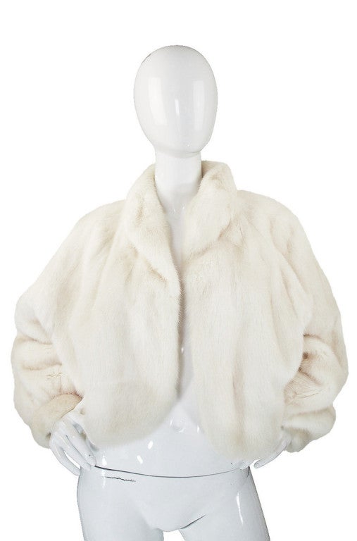 What an extraordinary and beautiful white mink evening jacket! It is easy to see the level of quality in this piece - the fur is extremely supple and soft. The jacket is pieced together in vertical stripes set extremely close together and matched