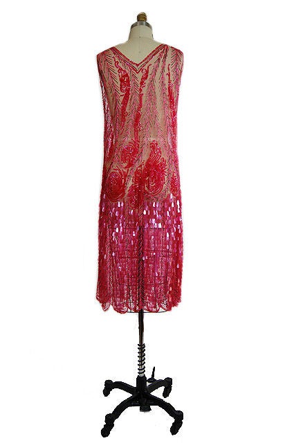 The color of this dress is outstanding - it's that perfect shade of pink with only shots of silver glass beads to break up the color! A classic art deco shift the gown is beaded from top to bottom in elaborate rows of pink sequins and pink and
