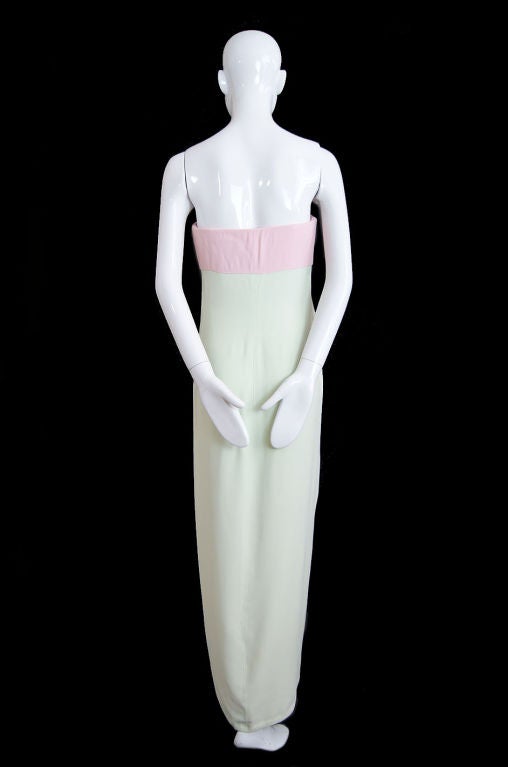 Stupendous late 1970s Valentino gown in wool crepe whose color combination feels fresh and startlingly new. A pale blush pink bodice mixes with soft mint green. The somewhat romantic innocence of these two colors is contrasted sharply by the all out