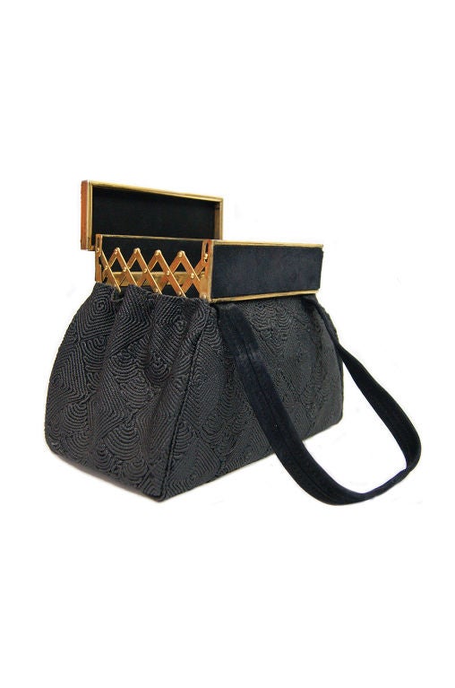 A really unusual and distinctive early 40s bag that will make a phenomenal evening piece to add to any outfit. silk cord is tightly applied and coated to create a fantastic diamond like design that covers the entire bag! The top is a clever design