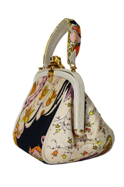 How can you not love Pucci and to combine Pucci with the shape of the perfectly feminine little frame bag - I die! Classic Pucci print makes the exterior of this bag an instant recognizable iconic piece. The shape is wonderful - a mini treasure