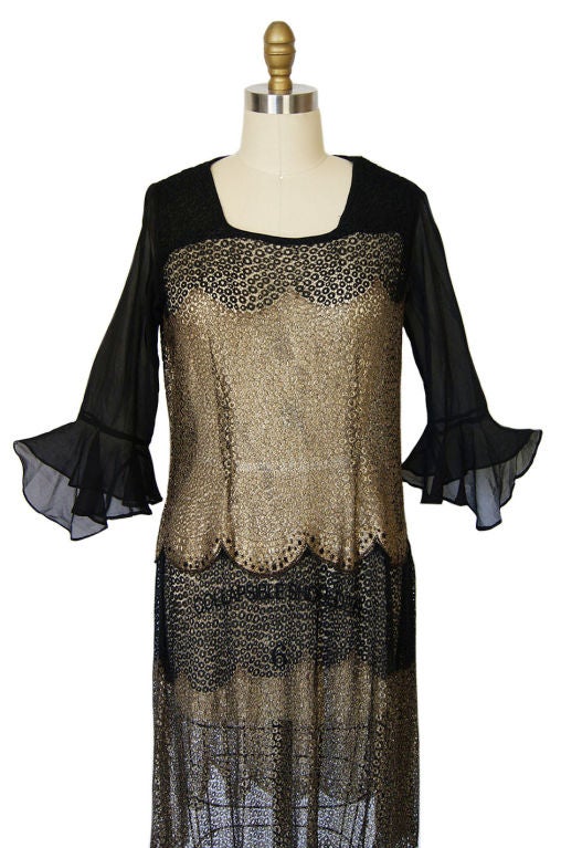 Fabulous 1920s piece with the elusive and hard to find real gold metallic thread lame. This one is even more special as that thread, along with its black silk counterpart has been hand woven into the brilliant circular design that you see. Open cut