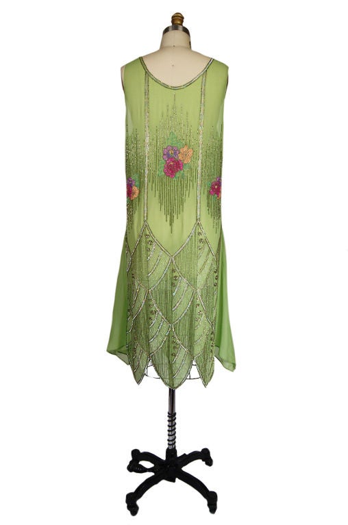 Please do not buy - this item is reserved for a client<br />
<br />
Exquisite 1920s dress in a remarkable and unusual shade of soft green. The silk chiffon is finished with mind boggling tiny stitches and that amazing pointed hem that follows the