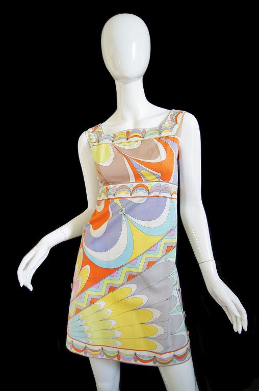 A gorgeous early Pucci that is a killer mix of pastels colors all in that classic Pucci print! The dress is made from a thick, almost canvas like cotton which works to really hold that terrific tent shape while still managing to give a hint at the