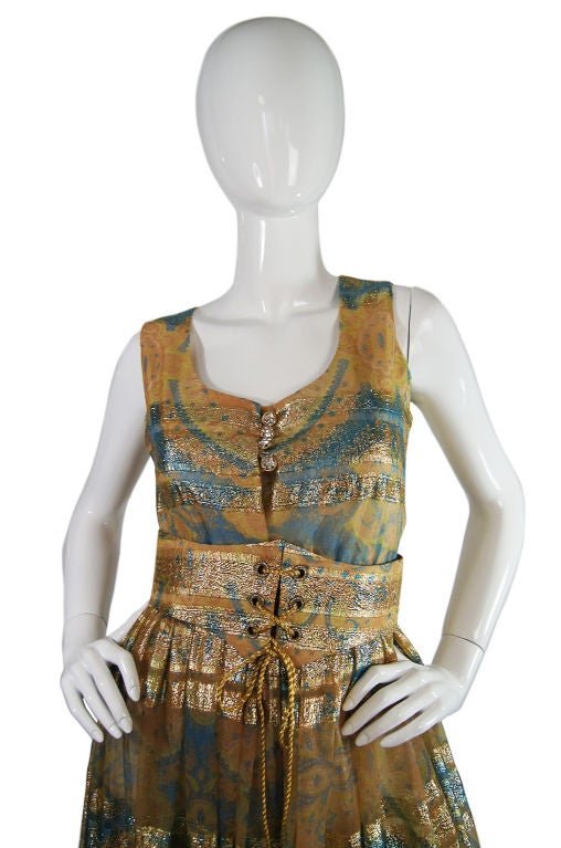 This is a fantastic 1960s jumpsuit from Oscar De La Renta! Its is shockingly light - I know it looks like it should not be with the gold - at first glance it appears to be a brocade, but the fabric is actually a light weight georgette that I believe