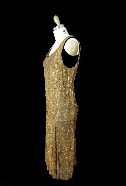 Spectacular gold netting flapper dress in absolute wearable condition, which is getting harder and harder to find! The dress is made from a gold silk tulle netting that has gold sequins, glass beads and gold thread applied to make that opulent,
