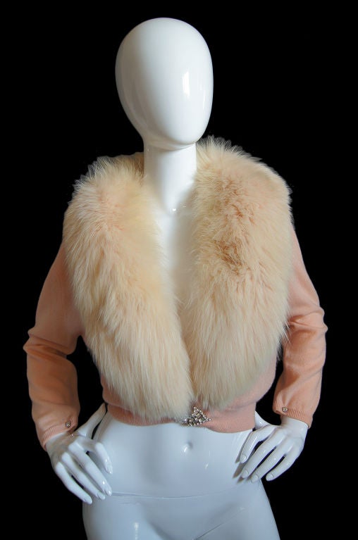 This is the ultimate Hollywood glamour girl vintage sweater! A soft baby pink cashmere is topped by a thick luxurious fox fur collar that is hand dyed to match the pink of the sweater! Double sided French cuff look, rhinestone buttons, end each