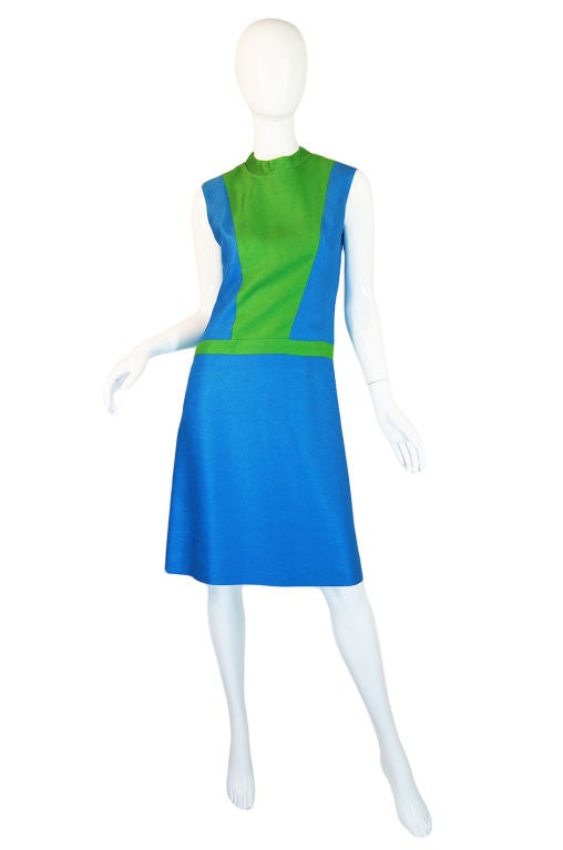 Color blocking is huge for the season and this little raw silk shift in a fabulous blue mixed with a lime green is a great piece that you can top with a jacket now and then wear on its own come warmer weather. The cut is deceptively simple -