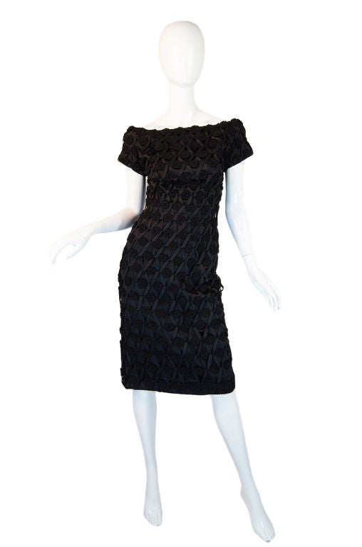 The exterior of the dress is fashioned out of black ribbon and crocheted rosettes. Every one of those rosettes has been hand applied into place and the ribbons woven and crossed through to form that beautiful exterior. The base is a block heavy