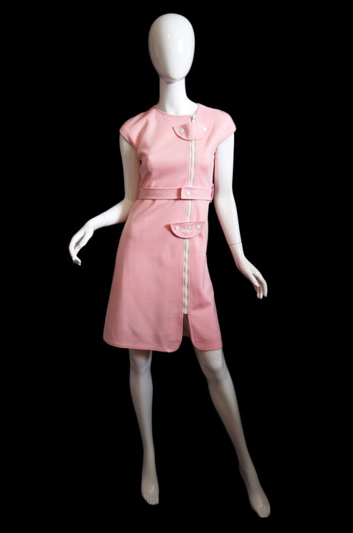 The first thing you must know about this dress is that it is a true baby pink. It has photoed in a more vibrant hue that how it presents in person. Think Barbie doll pink for this one! It is an incredible and iconic piece that is very very hard to