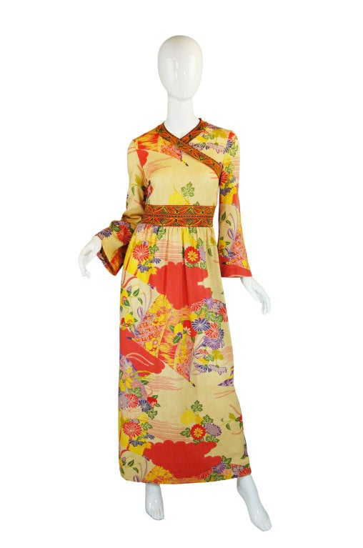 A gorgeous and dramatic Goldworm print dress that has a fantastic Asian inspired print. A faux criss cross bodice is edged with a contrasting print which is also picked up at the waist banding. The colors on the main part of the dress are soft and