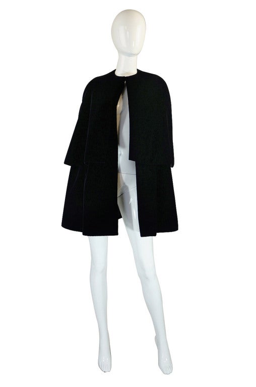 A truly rare, numbered piece from the Fall 1967 Haute Couture collection. The silhouette is very minimum in design, with the emphasis on the understated drama pf the tiered silhouette and simplicity of cut. It is made of an inky black velvet with a