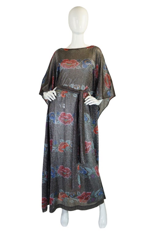 This is one of the holy grails of vintage Missoni - a metallic lurex floral caftan dress! Done in a stunning pewter lurex with bands of beautiful flowers circling the fabric at every 6 inches or so top to bottom. The fabric is feather light so