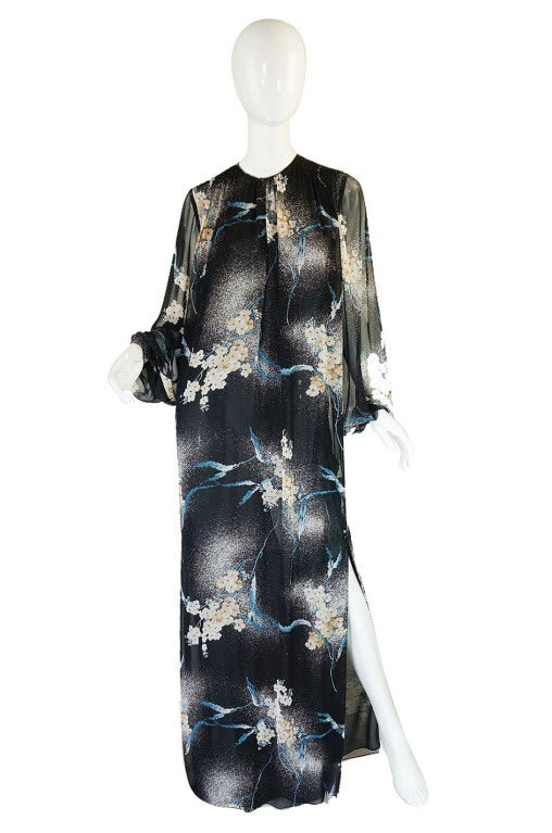 A late 1970s Hanae Mori caftan maxi dress done in a feather light silk chiffon. The gown is cut super model long and is constructed of two layers of almost weightless silk. I love the exotic Asian feel combined with the sleekness of the seventies