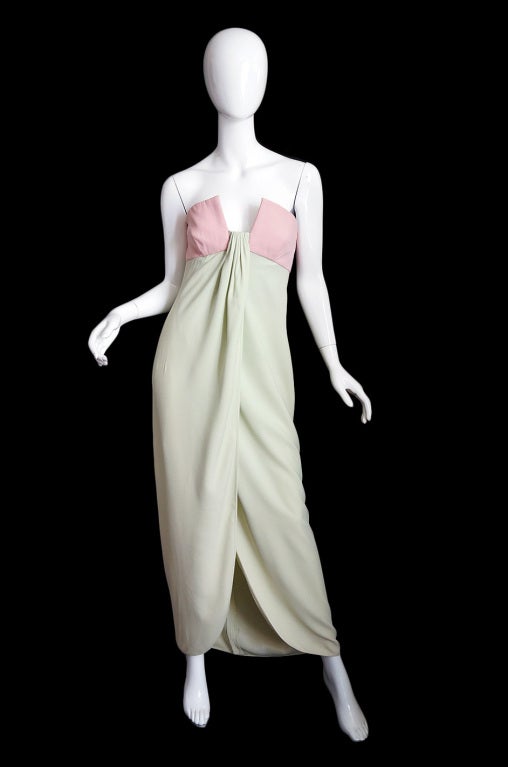 An iconic Valentino gown done in silk crepe whose color combination feels fresh and startlingly new. A pale blush pink bodice mixes with soft mint green. The somewhat romantic innocence of these two colors is contrasted sharply by the all out impact