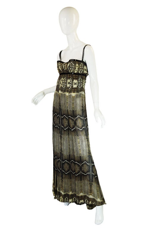 Straight from the closets of a couture buying socialite, comes this 2006 Roberto Cavalli runway gown. It is pure Cavalli - both sexy and jet set chic. The gown is constructed of yards and yards of luxurious thick silk custom screened with a python