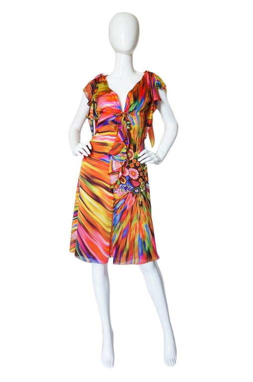 This is a gorgeous, bright and vibrant little dress made of such a beautiful printed silk! It has that coveted Gianni Versace Couture label that dates prior to his demise and his aesthetic shines through! It is constructed of light as air silk