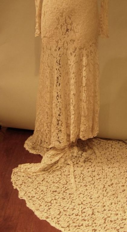 This wedding gown was worn once and kept in remarkable condition. Made for a very slender, tall [5'7] size 4, there is quite a bit of lace available for alteration from the veil which is not usable as the tulle didnt fare as well as the lace.<br
