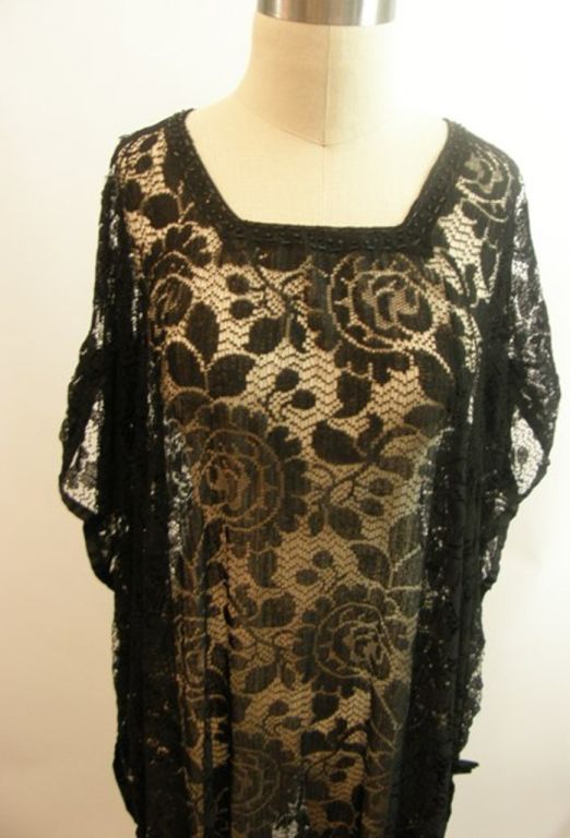 Pretty black lace long dress, circa 1910–1920s.  In excellent condition with beading along the neck.  This lovely overlay will fit most everyone. A bodysuit would be a good choice for an underpining--VERY Isadora Duncan (look her up and you'll know
