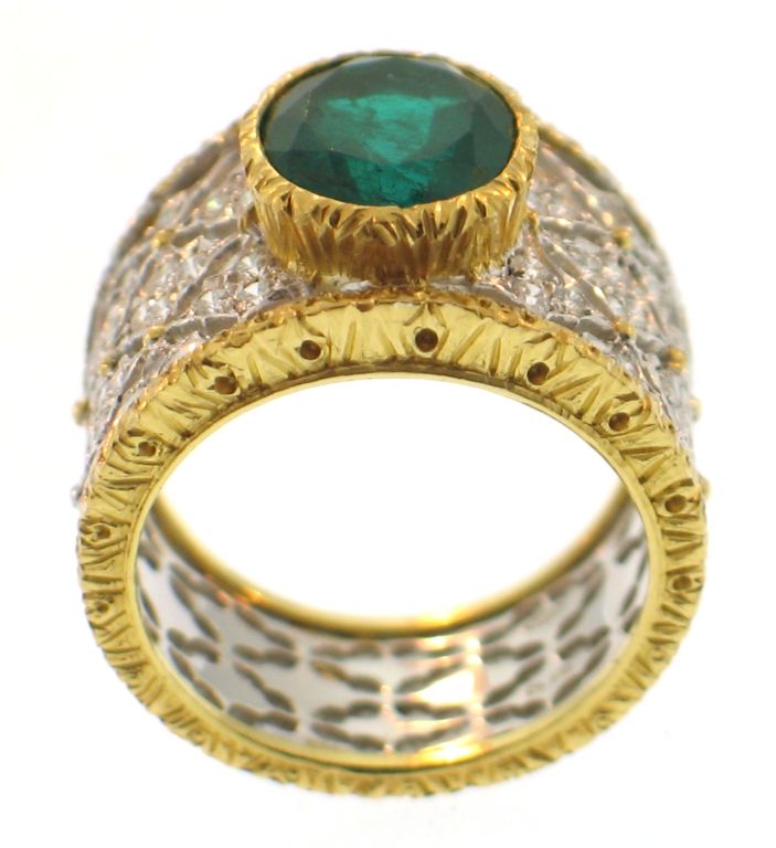 Classic Buccellati tapered ring design with deep green center oval cut emerald and accent diamond throughout in a nice wearable size. Marked M. Buccellati