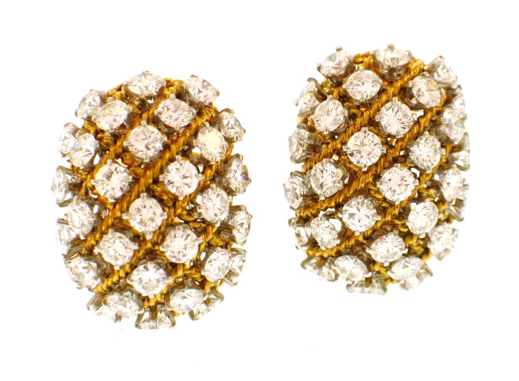 This stunning pair of VAN CLEEF & ARPELS earrings feature a twisted lattice design with large diamonds in a bombe shape. They feature post and omega backs and can also be worn as lapel clips. French assay marks.