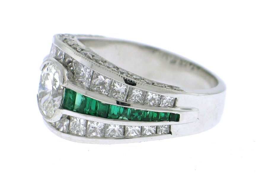 This fine JEWELS BY STAR (JB STAR) ring features a heavy platinum mounting with VS G-H quality diamonds and exceptionally clean bright green emeralds. Notice the JB Star hanmade signature plate in the under carriage of the ring.