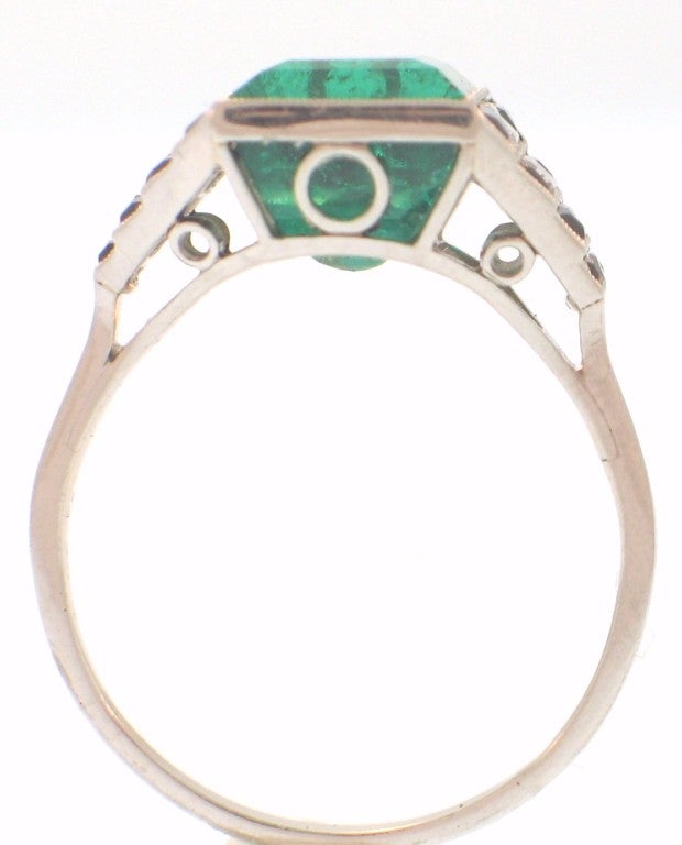 This beautiful Art Deco ring featuring and emerald-cut emerald weighing approximately 5.00 carats, accented at the sides by diamond and onyx graduated steps.  The perfect use of boldness of color and geometric forms, this ring is the ultimate Art