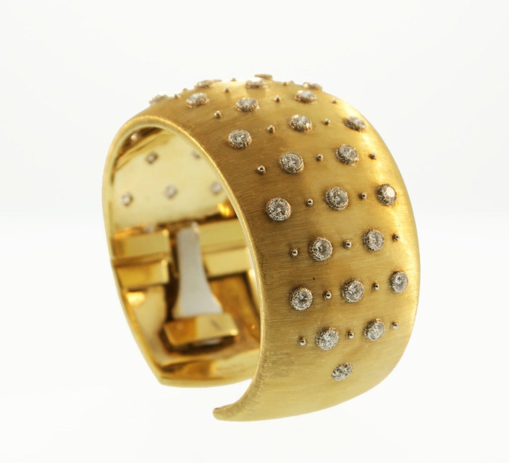 Own a classic piece of Buccellati!  This wide brushed gold cuff id studded with brilliant round diamonds and accented by gold beads.  A beautiful look for any wrist.