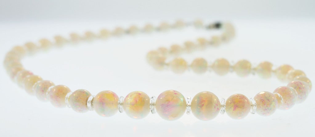 A beautiful graduated bead necklace composed of richly colored opal beads accented by rock crystal spacers.  This necklace was made by Tiffany & Co. during the vibrant Art Deco period and is as elegant and fashionable as it was first created.