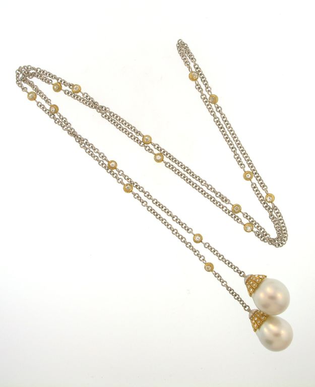 18k white and yellow gold Buccellati earring and necklace lariet suite. The necklace has two south sea drop pearls measuring 16mm (smallest dimension and the earrings have two south sea pearls measuring 13.5 mm (smallest dimension). The necklace