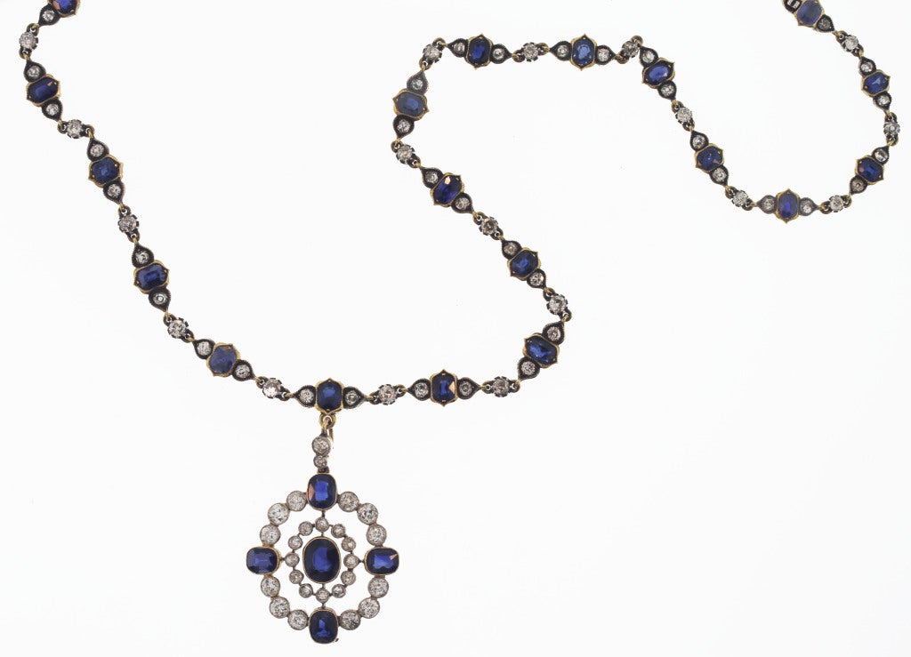 This necklace features the classic combination of sapphire and diamonds which have been used for centuries.  Made during the late 19th century, the links were designed with oval sapphires flanked by old mine diamonds all within a unique gold border.