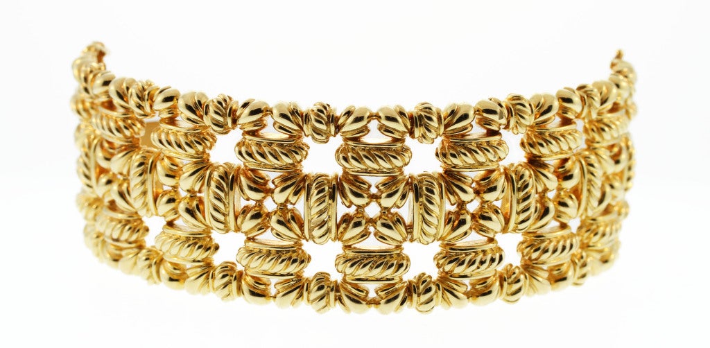 A bold statement piece, this 18 karat yellow gold bracelet is designed with stylized polished gold links of lozenge shaped and ropetwist design.  Great for everyday wear.