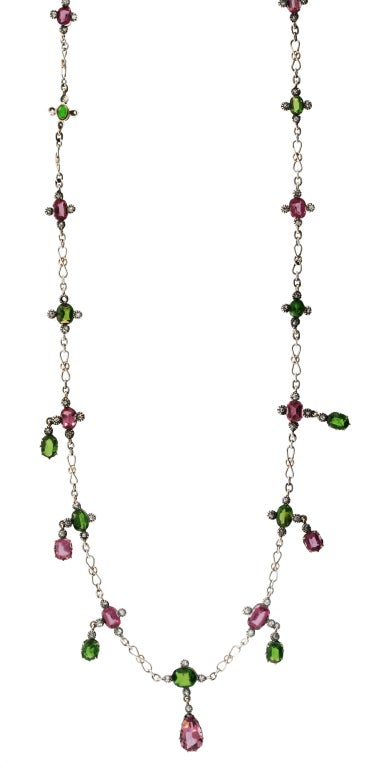 This delicate handmade platinum and gold link necklace features vibrant colored pink sapphires and demantoid garnets with rose and old mine cut diamond accents.  A unique and feminine necklace that falls beautifully on the neck that can only be