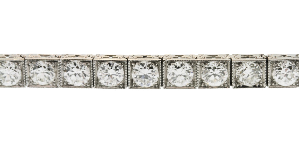 This straightline bracelet features approximately 12.00 carats of extremely well matched and fine old Europen cut diamonds.  Set within platinum box links, each diamond is highlighted and of superior quality.  Made by the American jewelry firm J.E.