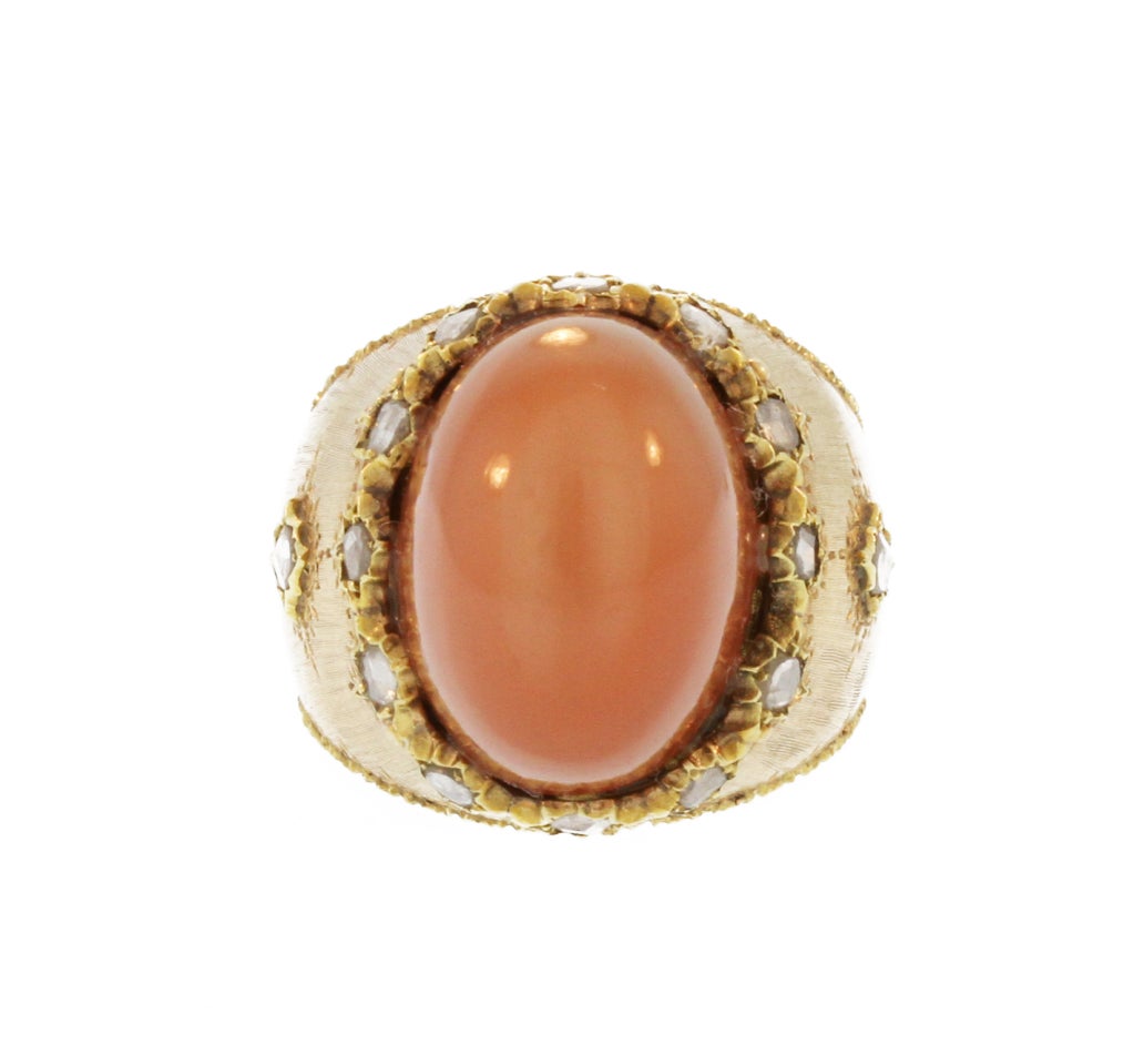This unusual ring by the famed Italian maker Mario Buccellati features an oval cabochon cat's-eye moonstone of a pinkish brown honey hue within a brushed gold mounting set with rose-cut diamonds.  A one-of-a-kind piece and a great addition to any