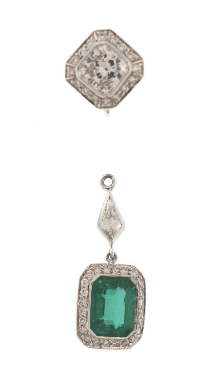 These stunning earrings feature emerald pendants set with two emerald-cut emeralds weighing 3.98 carats further framed and surmounted by round and kite-shaped diamond.  With the pendants being removable, the tops can be worn separately.  A versatile