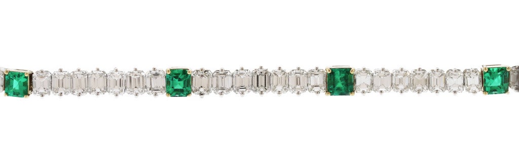 This stunning straightline bracelet features 7 square-cut emeralds spaced by slightly graduated bands of emerald-cut diamonds.  Of superior quality and color, this bracelet is a must have.