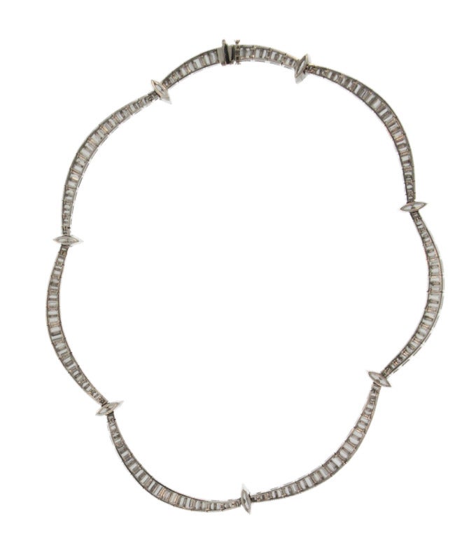 This stunning necklace is designed as graduated swags gathered by marquise-shaped diamonds, set throughout with 162 baguette and 7 marquise-shaped diamonds weighing approximately 28.00 carats, length 16 inches, gross weight 57.2 grams, mounted in