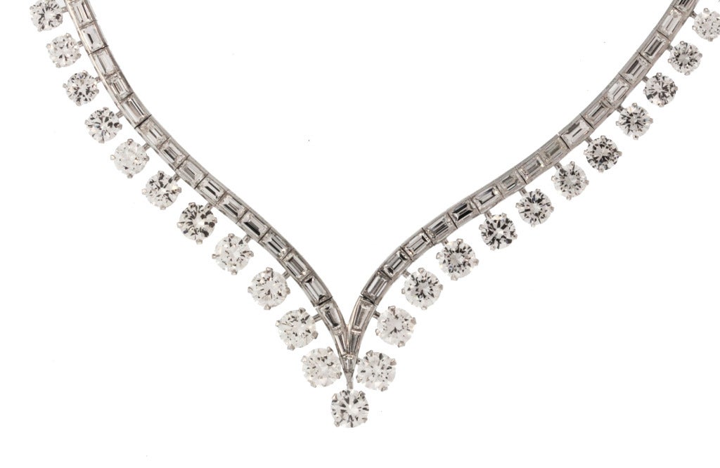 45 carats of large diamonds designed as a graduated v-shape necklace set in the center with band of 115 baguette diamonds weighing approximately 18.00 carats, supporting 73 round diamonds weighing approximately 27.00 carats, the center diamond has