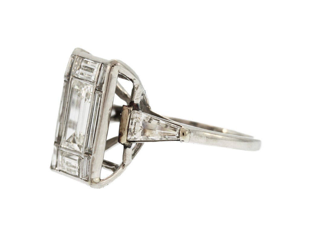 Wear a 10 carat look for a fraction of the price! Designed as a rectangular plaque set in the center with an emerald-cut diamond weighing approximately 1.50 carats, framed by 8 various sized baguette diamonds weighing approximately 1.50 carats,