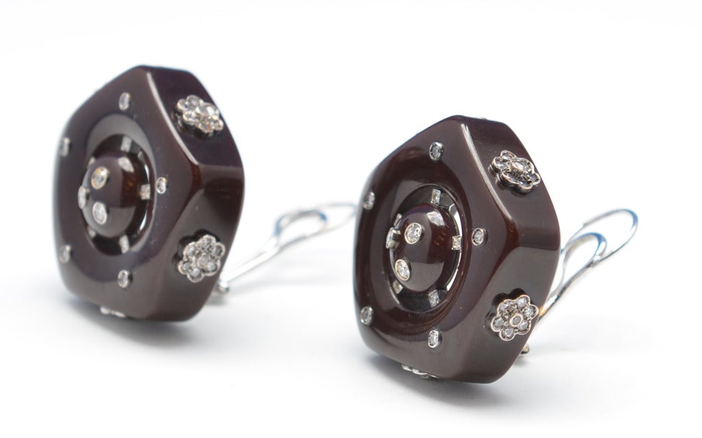 18 karat white gold, dark brown resin and diamond earclips by Michele della Valle, designed as rounded hexagonal resin rings with open centers decorated with bombe circular resin sections, all set with 104 round diamonds weighing approximately 3.00
