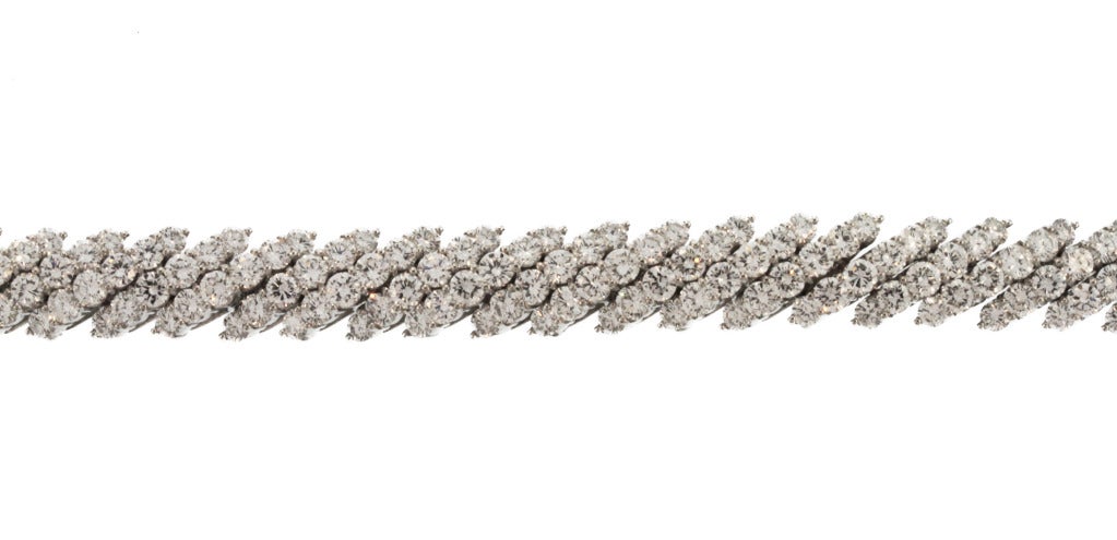 Platinum and diamond bracelet by Cartier, composed of numerous diagonal links set with 192 round diamonds weighing approximately 21.00 carats, gross weight 63.0 grams, length 7 1/4 inches, width 1/4 inch, signed Cartier, numbered 93090, stamped PLAT.