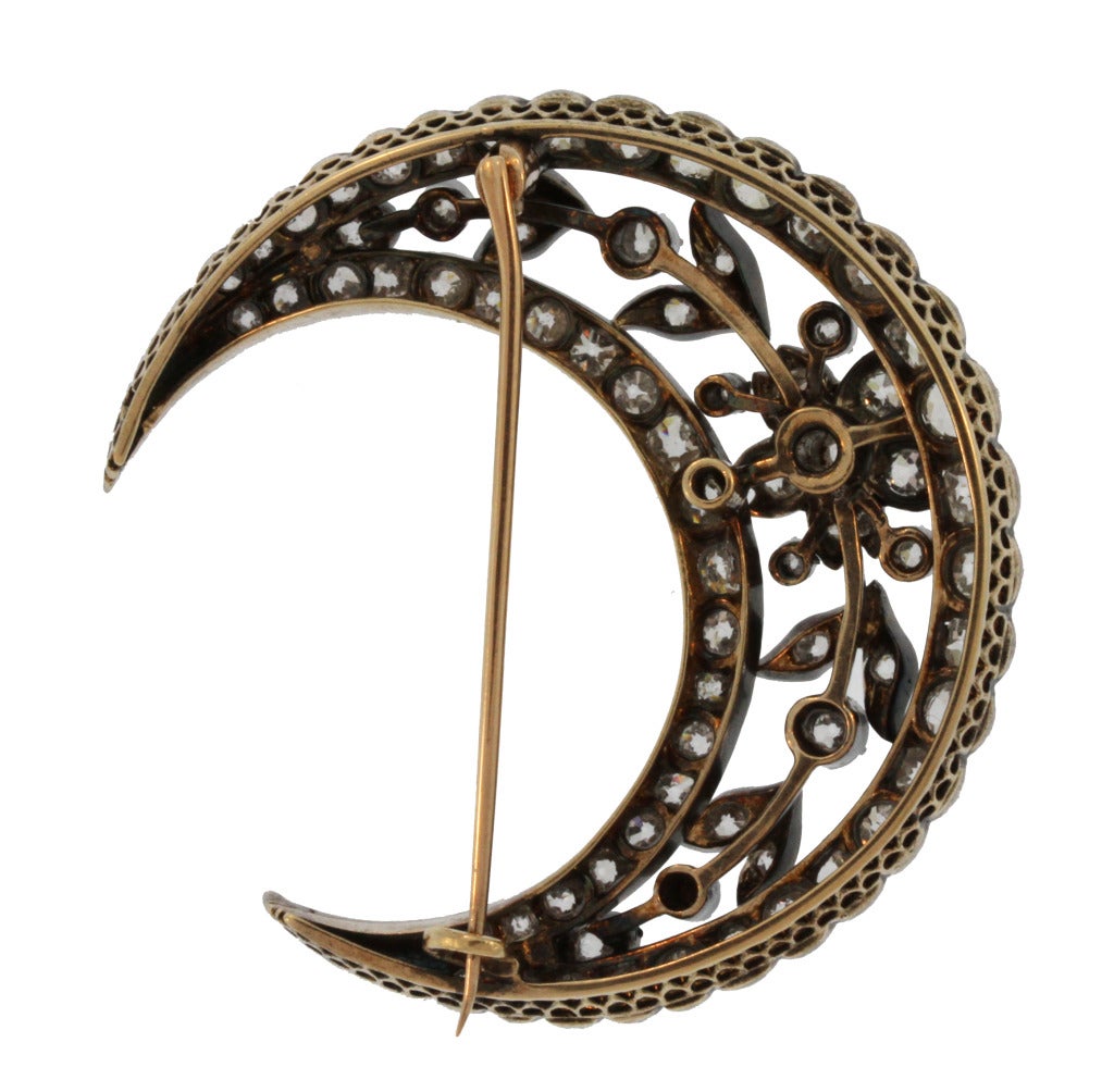 Silver-topped 14 karat gold brooch designed as an openwork crescent with a foliate motif set with old mine diamonds weighing approximately 6.25 carats, measuring 1 7/8 by 1 7/8 inches, pin is removable, mid 19th century.