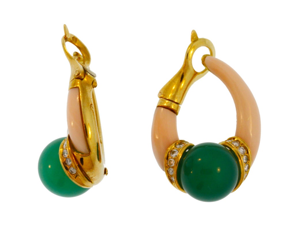 These unique earclips are designed as elongated hoops set at the bottoms with chrysoprase beads measuring 12.0 mm., flanked by bands of small round diamonds weighing approximately 0.50 carat, then completed by carved coral segments, measuring 1 1/4