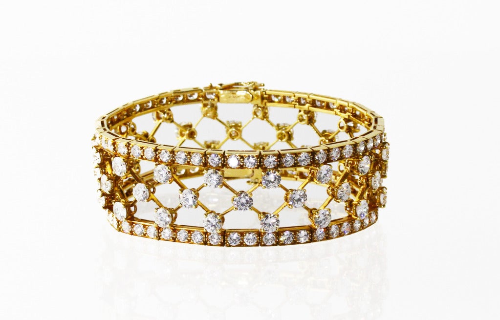 18 karat yellow gold 'snowflake' bracelet by Van Cleef & Arpels, designed as an openwork lattice design set with 144 round diamonds weighing approximately 28.00 carats, gross weight 46.9 grams, length 7 inches, width 7/8 inch, signed Van Cleef