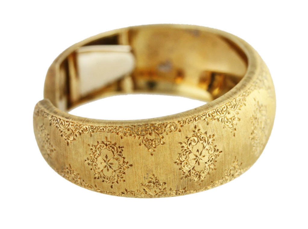 18 karat yellow gold cuff bracelet by Mario Buccellati, featuring a slightly tapered doomed cuff bracelet with hand engraved ornate design throughout, width tapers from 7/8 to 5/8 inch, signed Mario Buccellati, Italy, stamped 750, gross weight 37.8