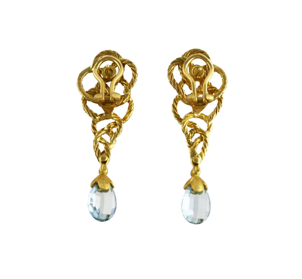 Pair of 18 karat yellow gold and aquamarine 'Crepe de Chine' pendant-earclips by Buccellati, designed as interlocking ropetwist curves supporting 2 briolette aquamarine drops measuring approximately 5.00 carats, gross weight 14.9 grams, measuring 2