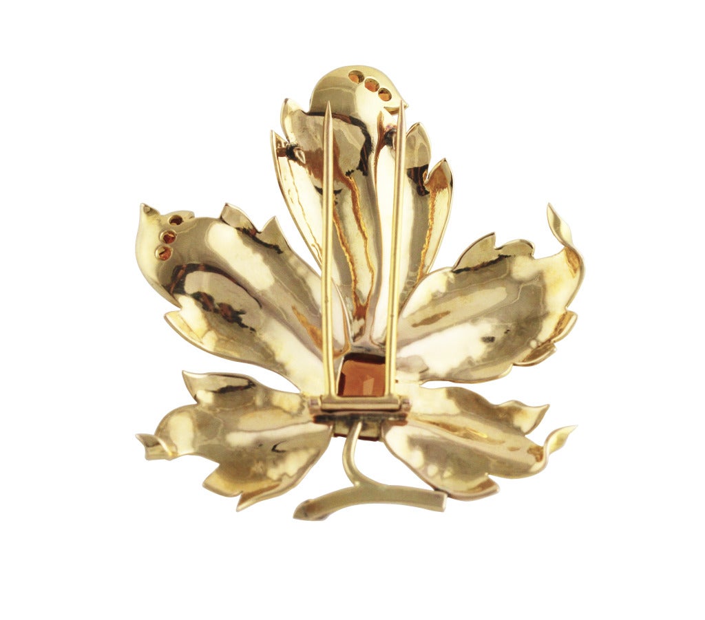 18 karat gold and citrine leaf brooch, designed as a polished gold leaf set in the center with an emerald-cut citrine weighing approximately 2.90 carats, 6 small round citrines weighing approximately 0.25 carat, gross weight 29.7 grams, measuring 2